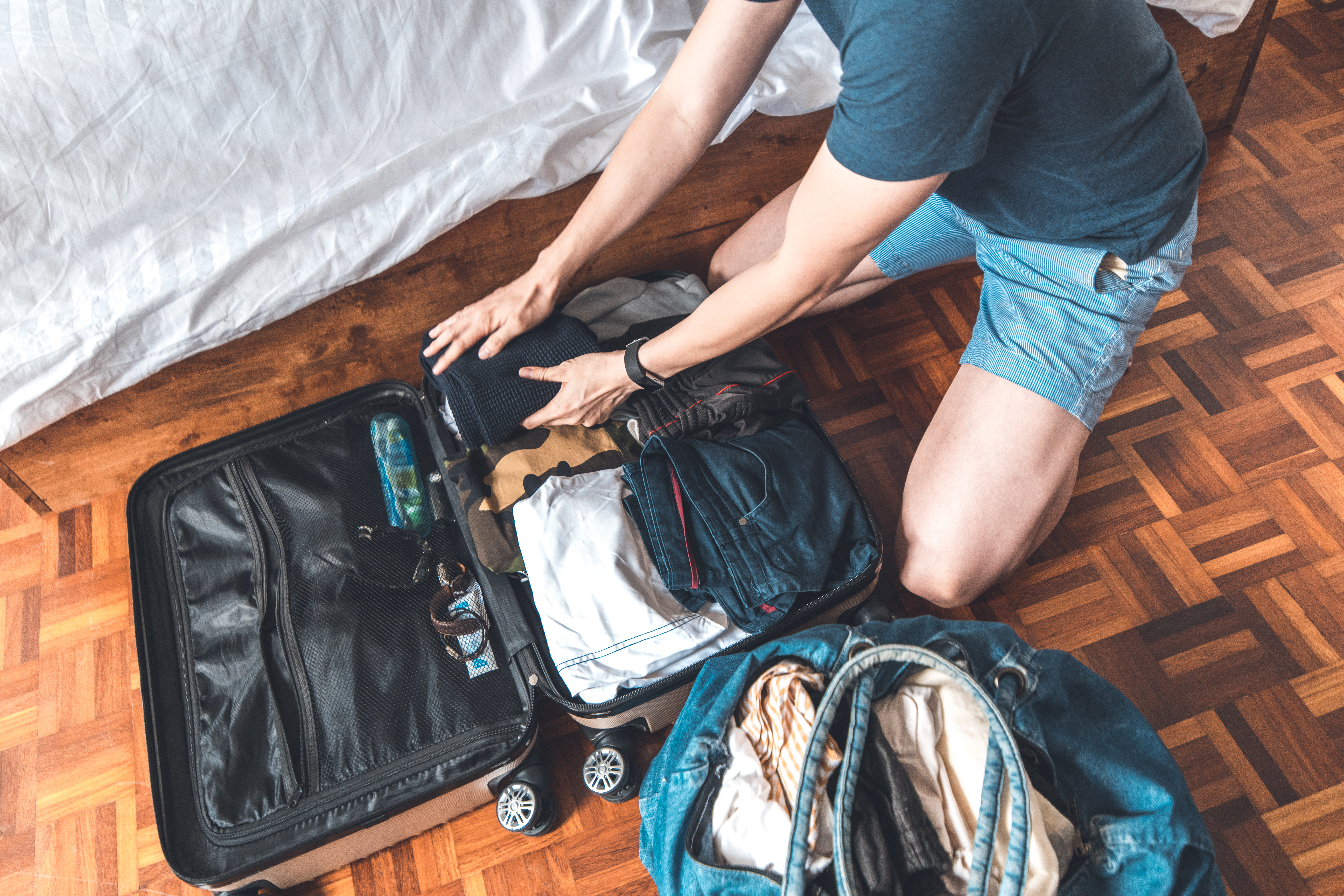 Man packing a travel suitcase