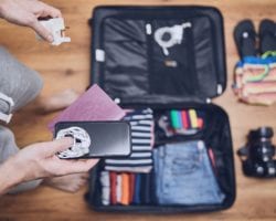 man holding traveling accessories