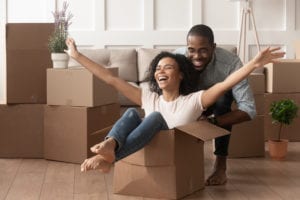 woman in box being pushed by man