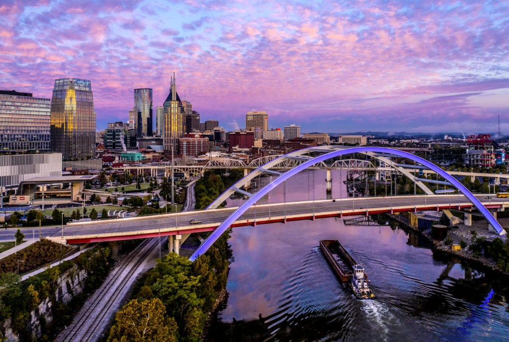 shot of nashville at sunset with a purple sky and vibrant city lights