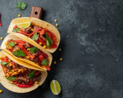 three tacos displayed on a table