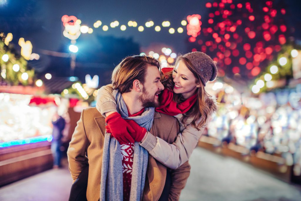 A couple enjoying a christmas festival. 