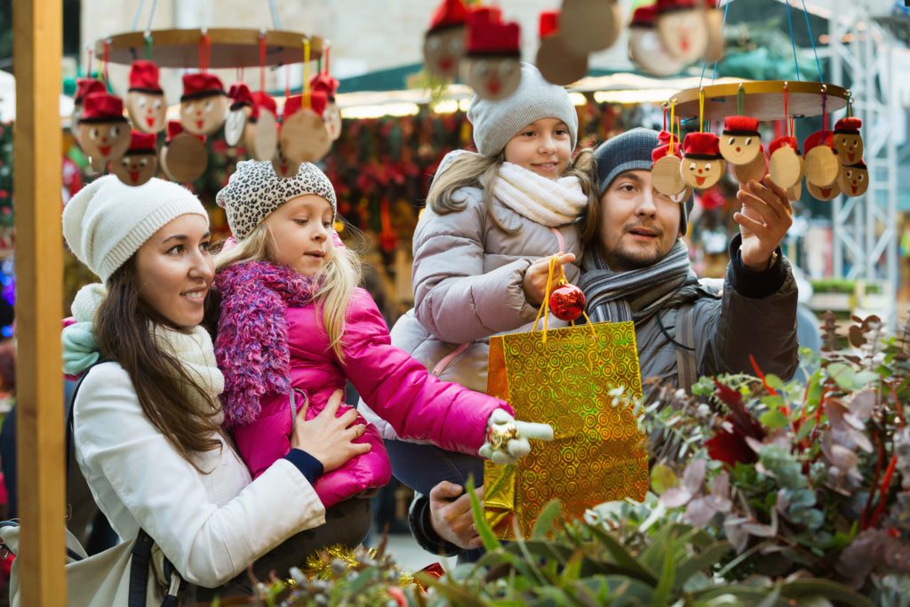 A family shopping at a christmas market. 