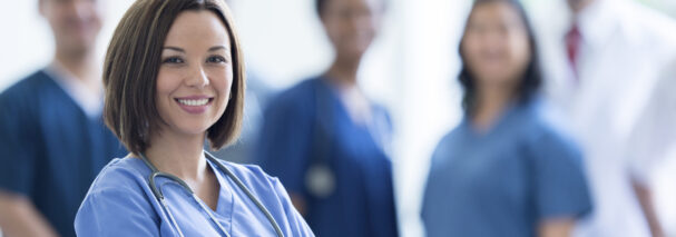 Nurse Happily Standing in a Hospital