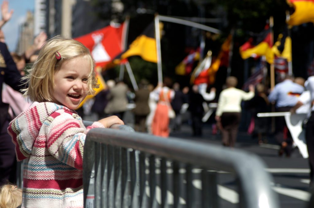 A young girl enjoying one of the best Thanksgiving day parades in America. 
