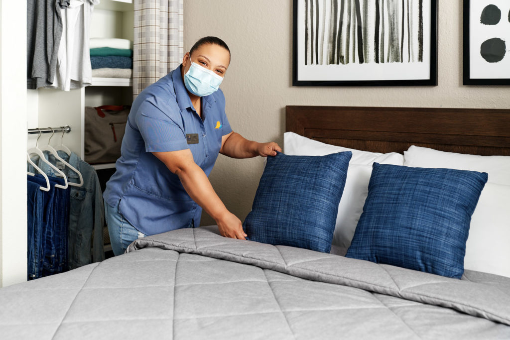 Housekeeper Cleaning a Suite