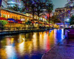 An image of the San Antonio River Walk at night.