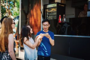 A couple getting food at a fall festival in Houston. 