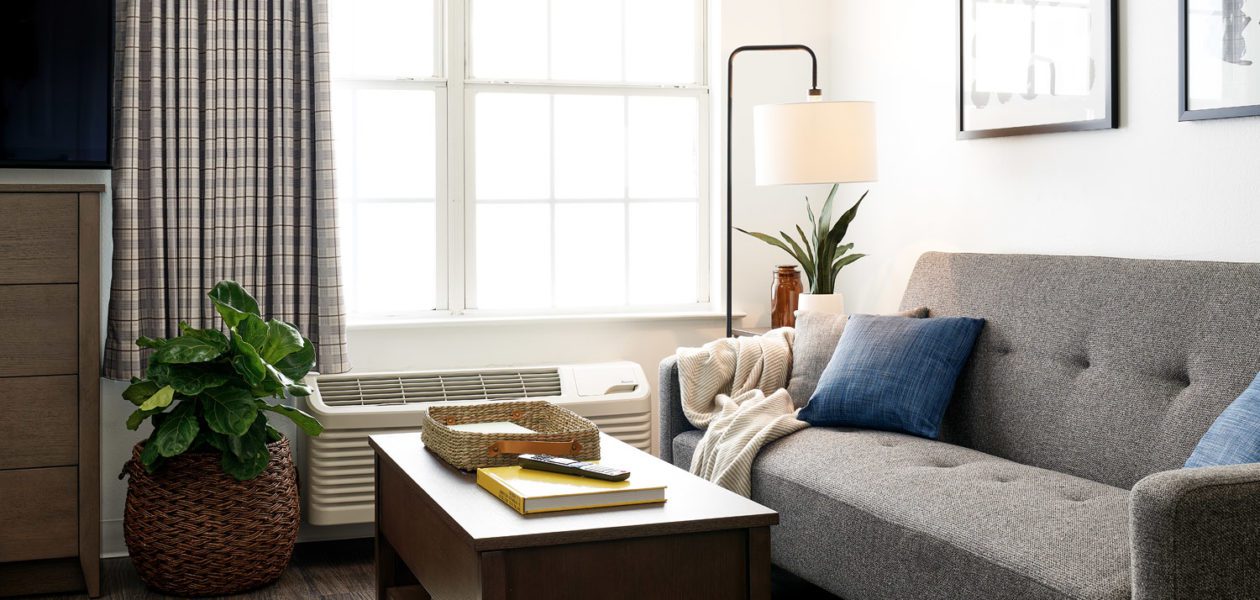 Living area in premium suites with sleeper sofa and lift-top coffee table.